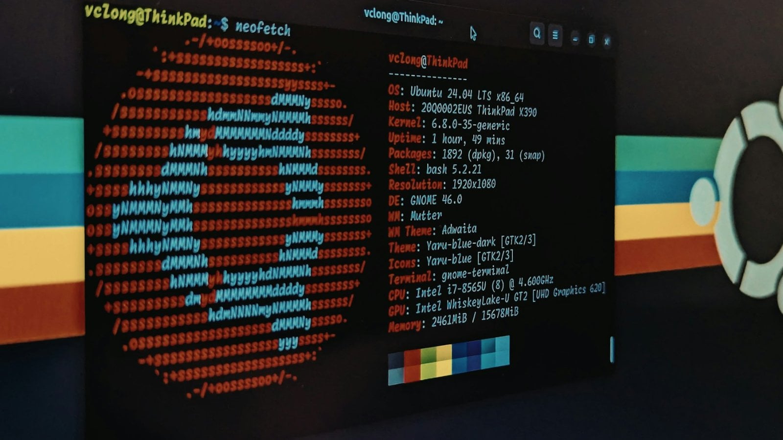 A computer screen showing a Linux terminal with system information and the Ubuntu logo rendered in coloured text